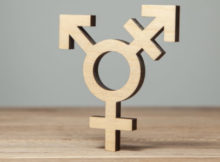 Symbol of transgender from tree on wooden table.